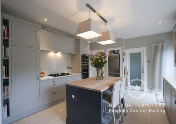 in frame kitchen featuring island and bespoke Cabinets